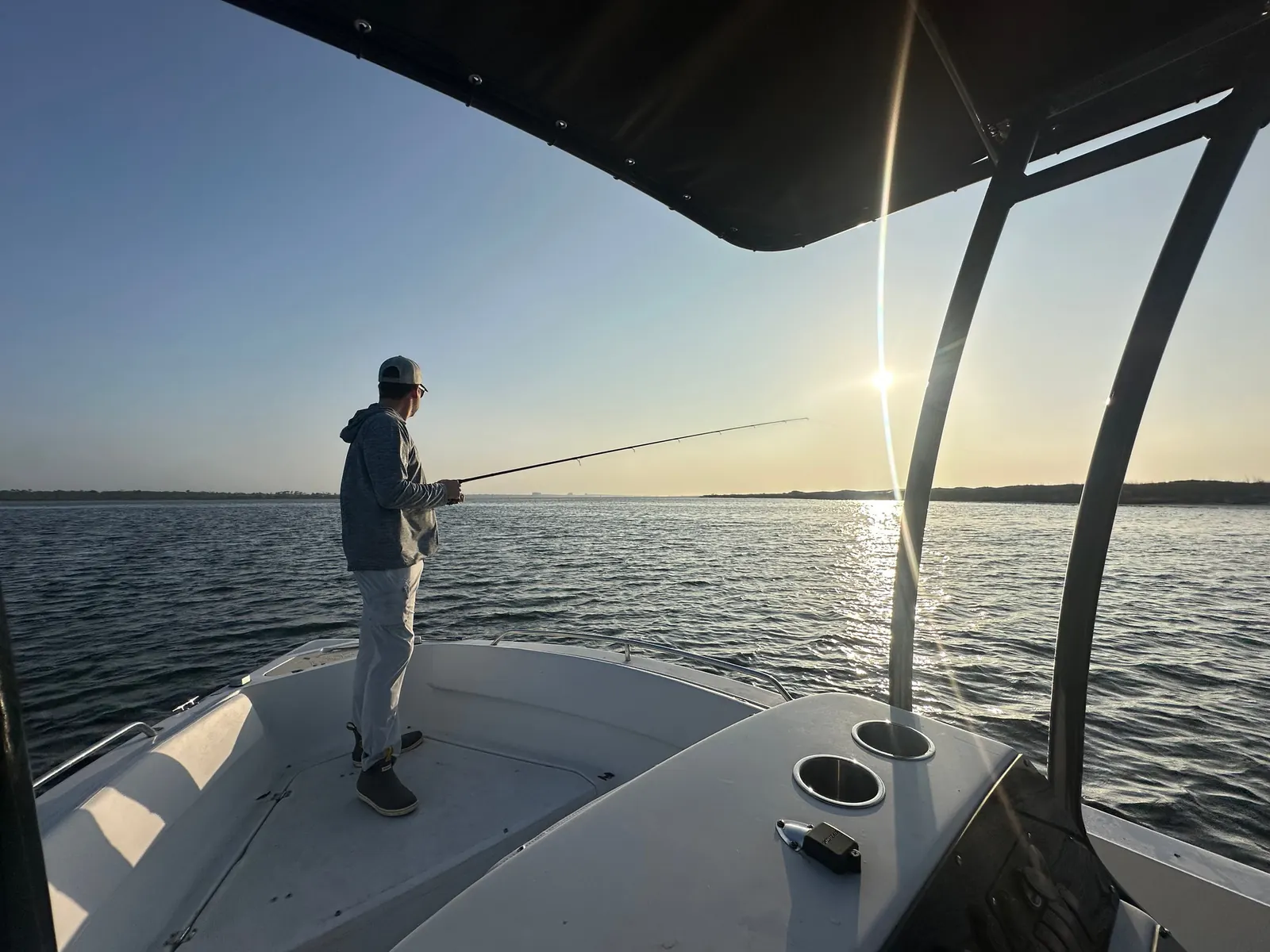 An angler casting from the bow of the Terrapin Charters boat in Perdido Key